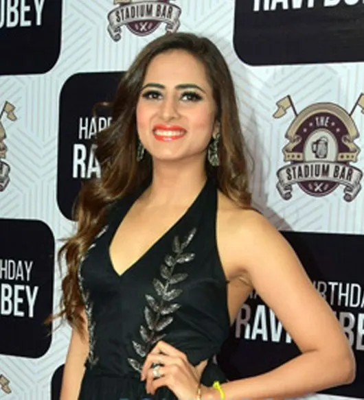 Sargun Mehta smiling in a black outfit at an event
