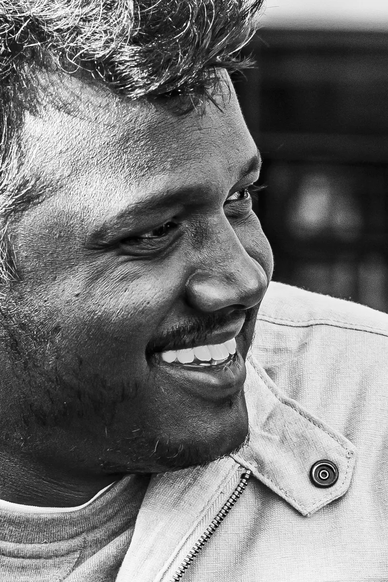 Black and white close portrait of Mari Selvaraj smiling