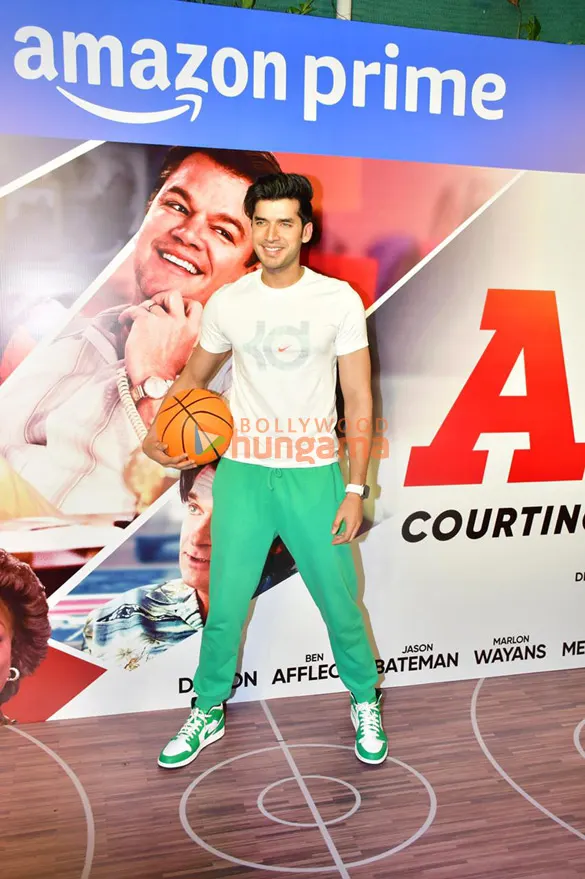 Paras Kalnawat holding a basketball at a film premiere