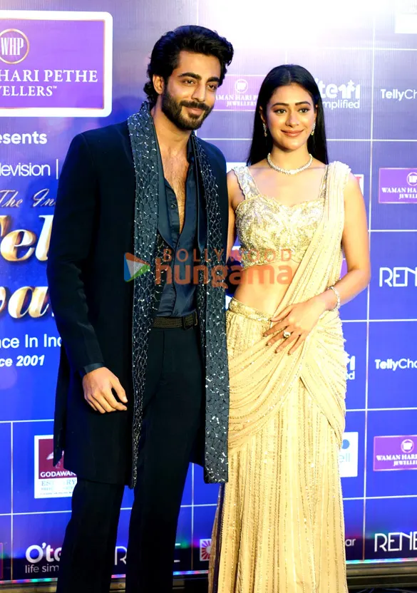 Hiba Nawab in a gold saree beside Krushal Ahuja