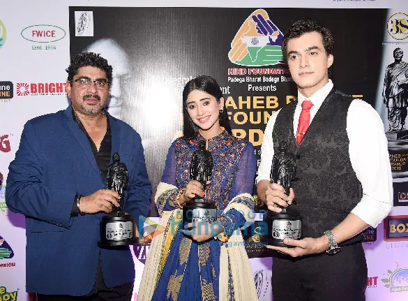 Rajan Shahi holding an award beside two actors