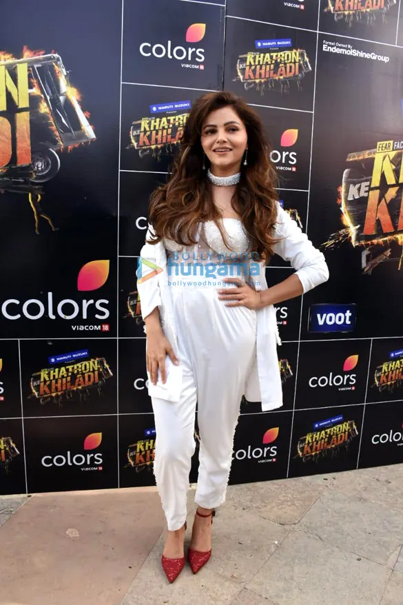 Rubina Dilaik in a white outfit in front of a Khatron Ke Khiladi backdrop