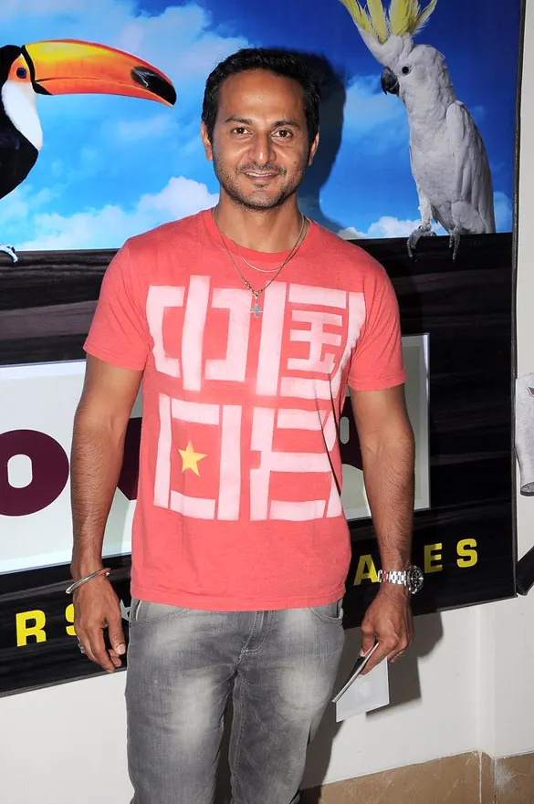 Nikhil Chinapa in a red printed T-shirt at a premiere