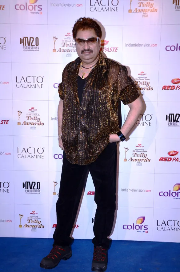 Kumar Sanu in a patterned shirt on a red carpet