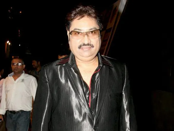 Kumar Sanu in a black jacket and glasses