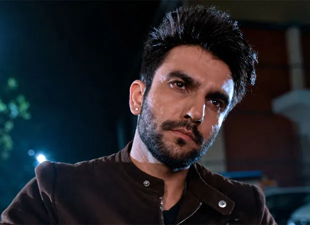 Ishhan Dhawan with a beard looking to the side