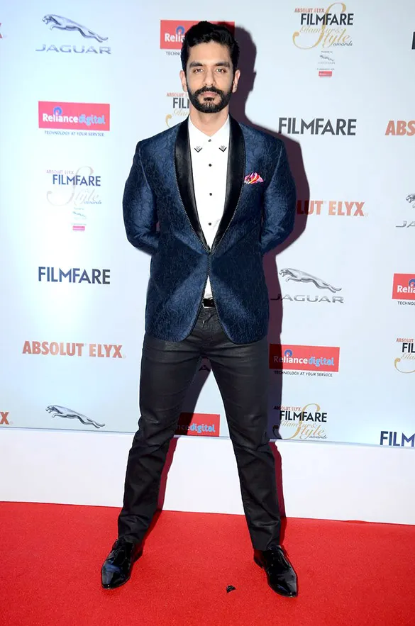 Angad Bedi in a navy velvet tuxedo on a red carpet