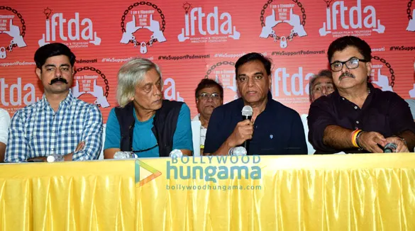 B.P. Singh speaking into a microphone at a press conference table