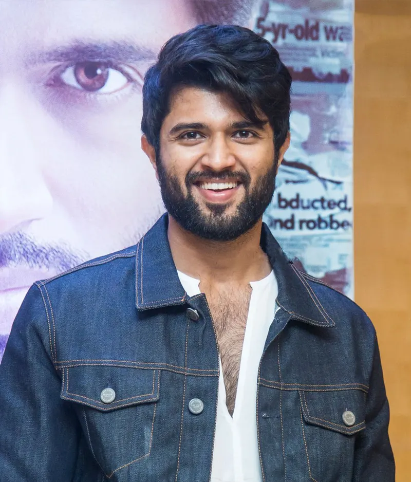 Vijay Deverakonda smiling in a denim jacket