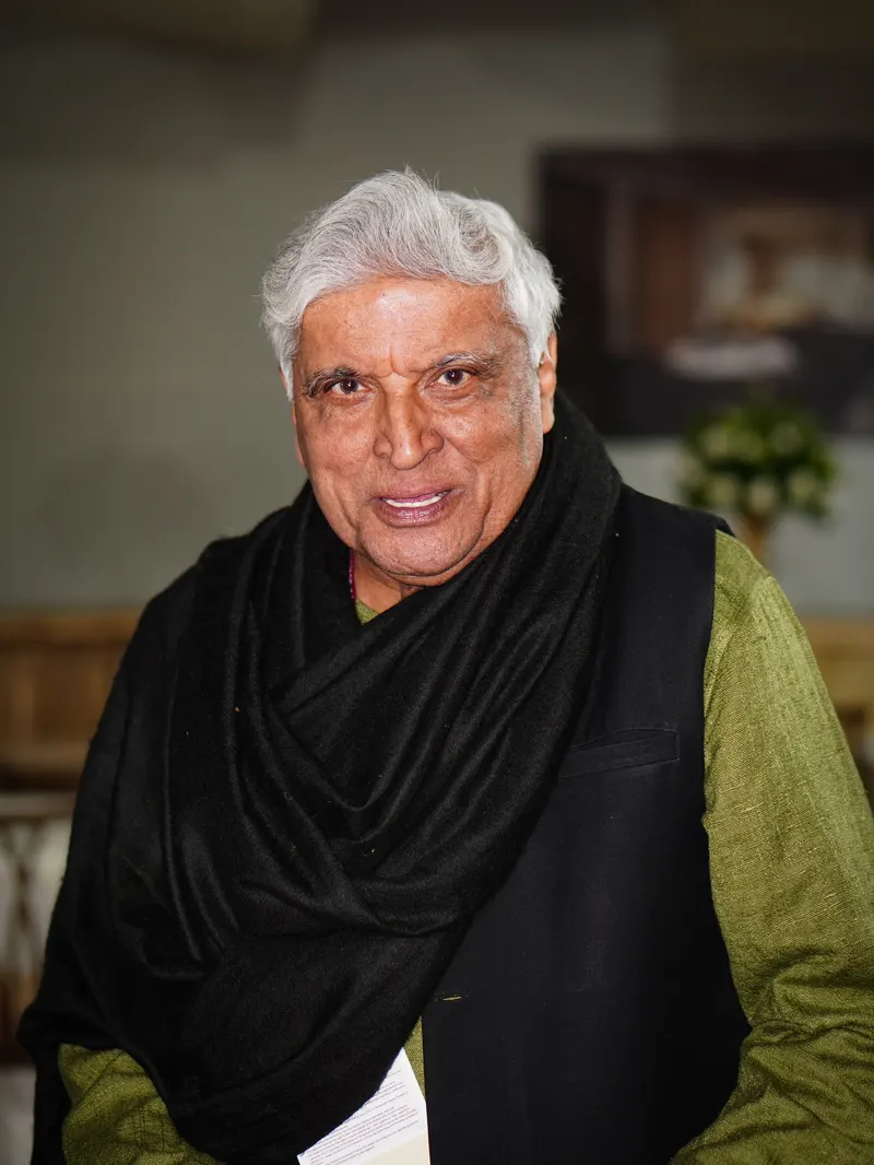 Javed Akhtar in a black shawl smiling