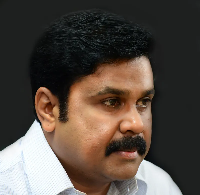 Close portrait of Dileep in a striped white shirt
