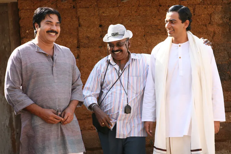 Saiju Kurup in white standing beside Mammootty and Ramachandra Babu