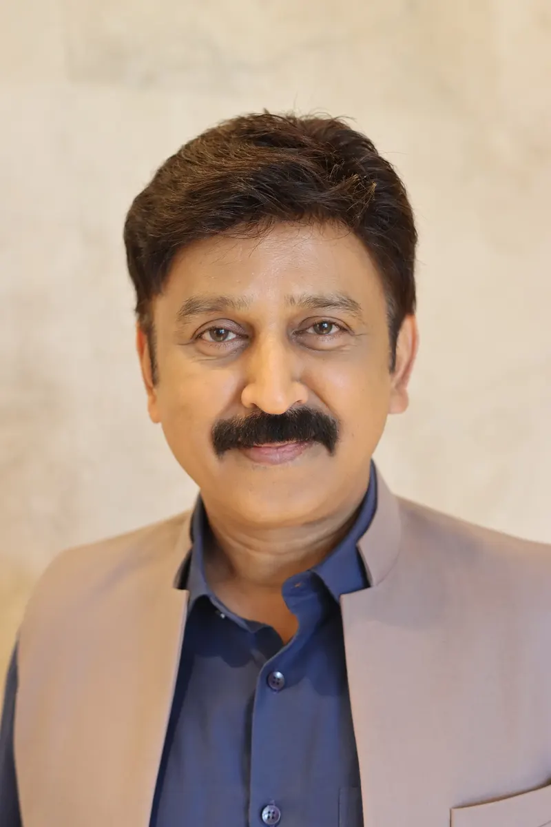 Portrait of Ramesh Aravind in a beige jacket