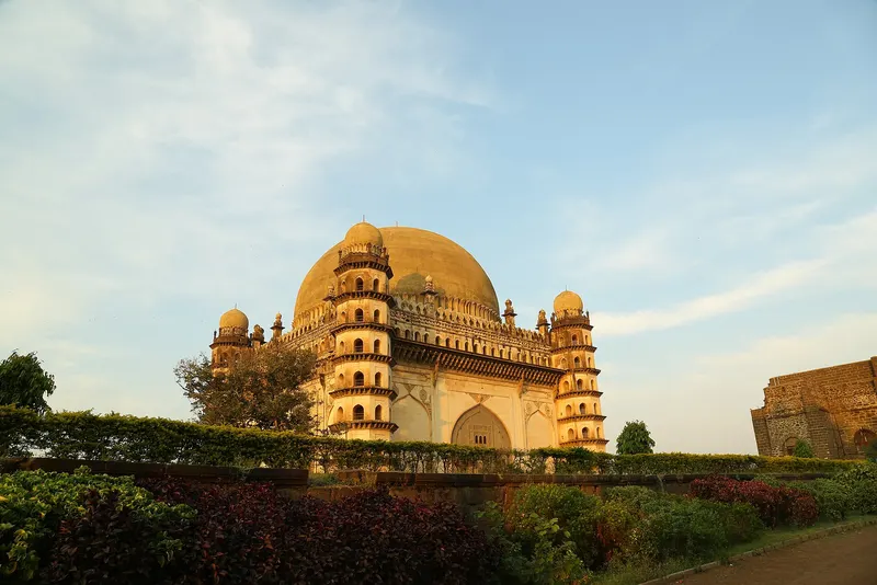The domed Gol Gumbaz monument at sunset