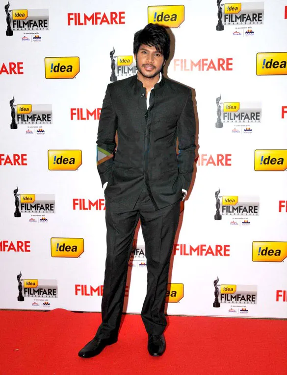 Sundeep Kishan in a black suit on a red carpet