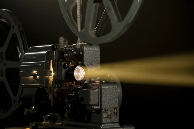 A vintage projector throwing a beam of light